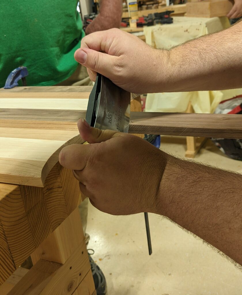 Using a scraper near the handle. 